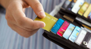 hand removing a credit card from a wallet